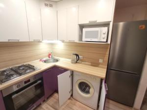 a kitchen with a stainless steel refrigerator and a dishwasher at Energia 2 Apartment in the city center in Narva +3 photos
