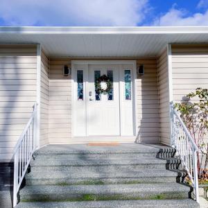 a white front door of a house with stairs at Quiet Three Bedrooms House in Victoria