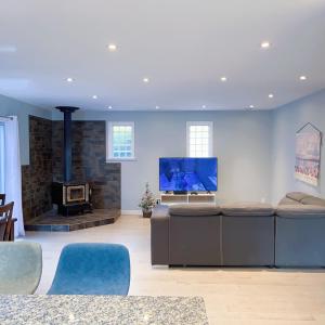 a living room with a fireplace and a tv at Quiet Three Bedrooms House in Victoria