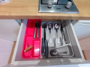 a tray with utensils in a drawer in a kitchen at Perfect Studio in Narva center in Narva