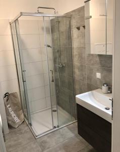a bathroom with a glass shower and a sink at R&K Classic Spirit Mariazell in Mariazell