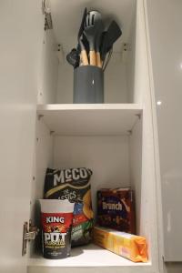 a cabinet with some food and snacks in it at Modern 2 bed flat Southampton- Close to Central Station & Shops in Southampton