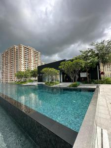 a large swimming pool in front of a building at Cozy Urban Suites Georgetown View in Jelutong