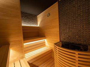 a wooden sauna with a wooden bench in a room at Loisir Hotel Kyoto Toji in Kyoto