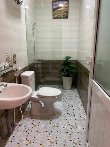 a bathroom with a toilet and a sink at Bonjour Hostel in Hue