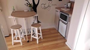 a small kitchen with a table and two stools at Private Guest Suite in Lyndhurst in Lyndhurst