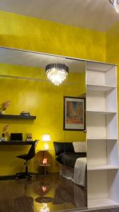 a bedroom with a bed and a yellow wall at Luxurious stay at Air Residences in Manila
