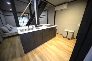 a bathroom with a sink and a large mirror at 宿ZEN in Nishi-kujō-Toriiguchichō