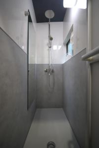 a shower with a glass door in a bathroom at 宿ZEN in Nishi-kujō-Toriiguchichō