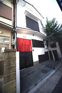 a red flag hanging on the side of a house at 宿ZEN in Nishi-kujō-Toriiguchichō