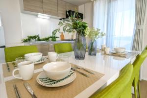 a kitchen with a table with plates and bowls on it at Premium Apartment Hotel Tokyo East in Tokyo