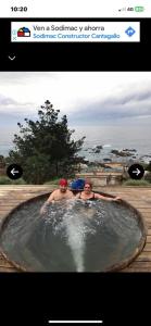 two men are sitting in a hot tub at HIPPOCAMPUS RESORT CONCON in Concón