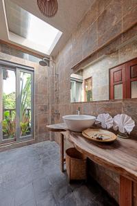 a bathroom with a sink and a large mirror at LittleTamCoc Boutique Villa Ninh Binh in Ninh Binh