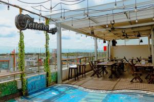 un restaurant avec une piscine sur le toit d'un bâtiment dans l'établissement Cordela Inn R Sukamto Palembang, à Palembang