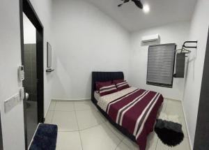 a small white room with a bed in it at Armaya Pool Villa Klang in Klang