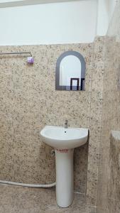 a bathroom with a sink and a mirror at Tea corner Guest house in Darjeeling