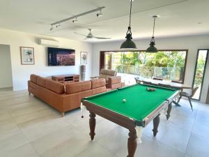 a living room with a pool table at Stylish Beach Side Gem - pool, beach ZG7 in Kawana Waters