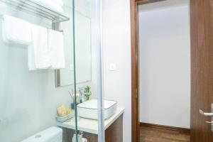 a white bathroom with a sink and a mirror at Wins Apartment in Hanoi +78 photos