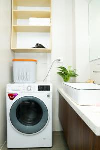 a washing machine in a bathroom with a sink at Wins Apartment in Hanoi