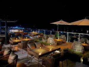 a patio with tables and chairs with candles on it at night at Coron 180 Hotel in Coron +9 photos
