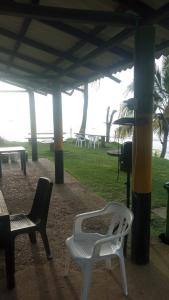 a group of chairs sitting under a pavilion at Cabañas el paisa tours in Arboletes