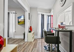 a living room with a table and chairs at St Paul Fry Street Den Suite#1 in Saint Paul +12 photos