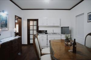 a kitchen with a wooden table and a dining room at Casa Macfarland Boutique in Ensenada