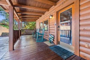 a porch of a house with two chairs on it at Bearfoot Pines - True Log Cabin - Wi-Fi, Hot Tub, Fishing, Deck with views! - Mins to PF in Sevierville +62 photos