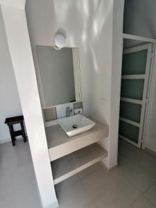 a bathroom with a sink and a mirror at V&G Las vacaciones que mereces in Ursulo Galván