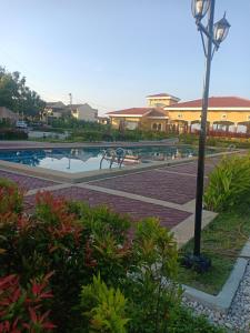 a resort with a swimming pool and a light pole at Noana Crib in Davao City