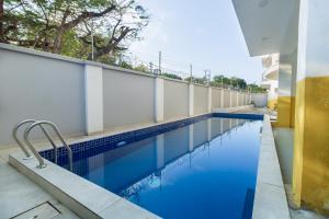 a swimming pool on the side of a building at Aqua Penthouse Beach Apartment in Mombasa