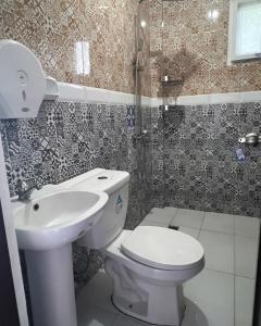 uma casa de banho com um WC e um lavatório em Charlotte's Vacation Home Busuanga Palawan 