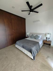 a bedroom with a bed with a ceiling fan at El mejor Departamento en Mérida in Mérida