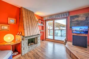 a living room with a fireplace and a television at Terrazza Dei Principi Few Steps From Ski - Happy Rentals in Sestriere