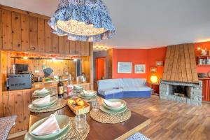 a dining room and living room with a chandelier at Terrazza Dei Principi Few Steps From Ski - Happy Rentals in Sestriere