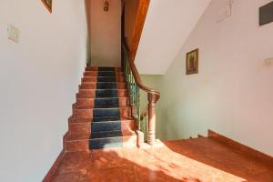 a staircase in a house with wooden floors at FabExpress Stargaze Beach in Anjuna