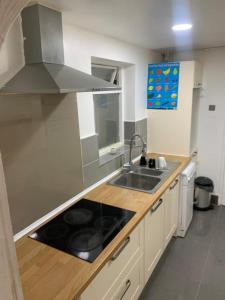 a kitchen with a sink and a stove at Gordon Road in Gillingham