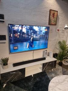 a large flat screen tv on a wall at CM Loft Maboneng in Johannesburg