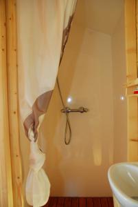 a towel hanging from a shower curtain in a bathroom at Gypsy Nature B&B in Jumelles