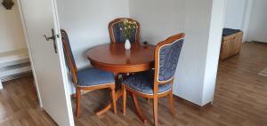 a wooden table with two chairs and a wooden table at FeWo-Kerstin, Malchin in Malchin