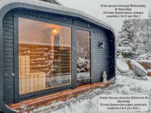 a cabin in the snow with a window at Alpine Apartments St-Sigmund in Sankt Sigmund im Sellrain