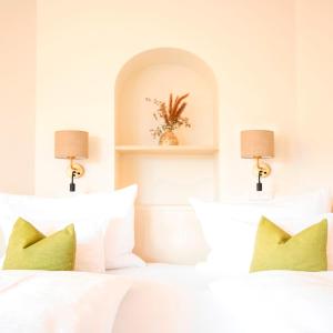 a bedroom with two white beds and two lamps at Ebner's Waldhof am See Resort & Spa in Fuschl am See