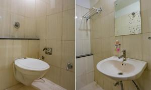 a bathroom with a toilet and a sink at FabHotel Midland in Bhopal