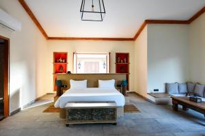 a bedroom with a bed and a couch at Anopura Jaipur in Jaipur