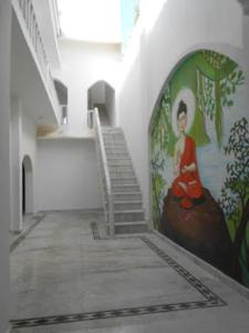 a hallway with stairs and a painting on the wall at Hotel Isabel Palace, Khajuraho in Khajurāho