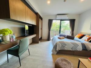 a bedroom with a bed and a desk and a window at HuaHin La Casita condo Quiet, cozy room Netflix#1 in Hua Hin +57 photos