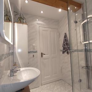 baño blanco con ducha y lavamanos en 51 m² zum Ausruhen und Entspannen im Grünen, 