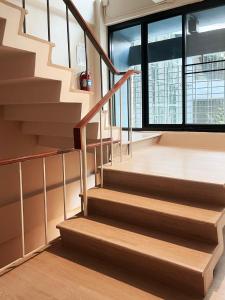 a staircase in a building with a large window at Rema residence China town Main Road in Bangkok +2 photos