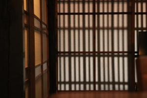 an open door with a window in a room at Kyonoyado Nijo Yumeya in Kyoto