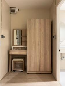 a bathroom with a wooden cabinet and a sink at Rema residence China town Main Road in Bangkok